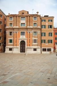 
a brick building with a clock on the front of it at Hotel Bucintoro in Venice
