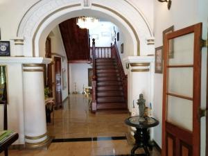 a hallway with an archway and stairs in a house at Manor House-Kandy in Kandy
