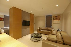 a living room with a couch and a television at The Ornate in Guwahati