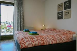 a bedroom with a bed with two towels on it at Roggebroek 13 in Stavoren