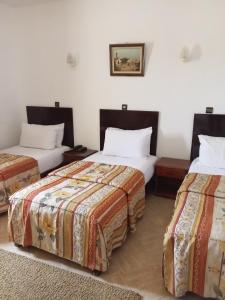 Postel nebo postele na pokoji v ubytování Hotel Al Kabir