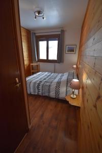 a bedroom with a bed and a window at La Souloise in Le Dévoluy