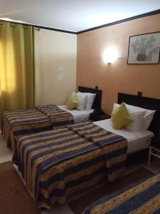 Postel nebo postele na pokoji v ubytování Hotel Al Kabir