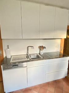 a kitchen with white cabinets and a sink at Ferienwohnungen Anna Altmann in Furth im Wald
