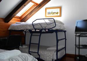 a room with two bunk beds in a attic at Pensión Panticosa in Panticosa