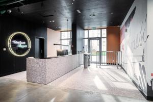 a lobby with a counter in a building at Apartamenty Depot Gdańsk in Gdańsk