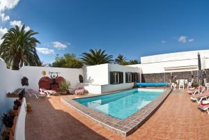 a villa with a swimming pool and a resort at Villa Yuca 13 in Costa Teguise