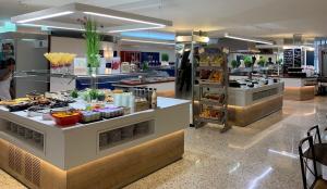 a buffet in a restaurant with food on display at Hotel Xaine Park in Lloret de Mar