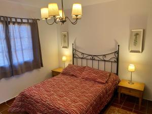 a bedroom with a bed with two night stands and two lamps at Casas Tomare I in San Bartolomé +8 photos
