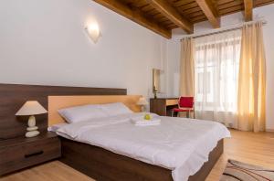 a bedroom with a large bed with a tray on it at Casa Nicolae Luxury Suites in Sibiu