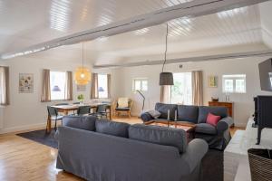 a living room with couches and a dining room at Sandet in Borre