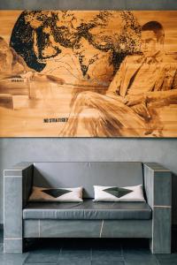 a couch in a room with a large painting on the wall at Asgard Hotel in Groningen