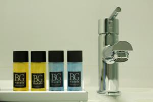 a group of four bottles of lipstick next to a faucet at BG Nautico Ebeso in Ibiza Town
