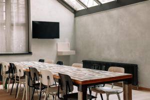 a conference room with a large table and chairs at Asgard Hotel in Groningen