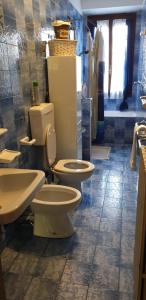 uma casa de banho com 2 WC e um lavatório em VILLA LAGO - GROUND FLOOR em Colico