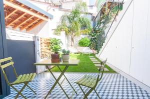 a small courtyard with a table and chairs on a balcony at Porto Moments Apartments by Portugal Collection in Vila Nova de Gaia
