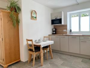 a kitchen with a table and chairs in a kitchen at Haus Anna in Ramsau am Dachstein