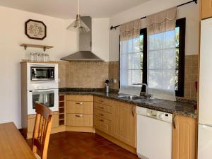 a kitchen with a sink and a stove at Casas Tomare II in San Bartolomé