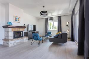 a living room with a couch and a fireplace at Apartments Bella Vista - Mlini in Mlini