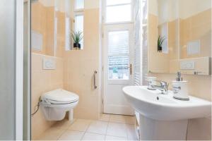 a white bathroom with a toilet and a sink at APTs in OLD TOWN PRAGUE by Michal&Friends in Prague +61 photos