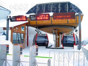 a bus stop with two cars parked in the snow at GVC 2-level apt New Gudauri in Gudauri