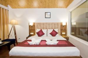 Lova arba lovos apgyvendinimo įstaigoje Hotel Avishi Greens, Manali
