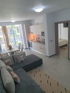 a living room with a couch and a kitchen at RELAX ALEZZI BEACH RESORT in Mamaia Sat/Năvodari +10 photos
