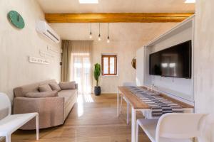 a living room with a couch and a table at Borgo Cantagallo Casa Olivia 2 in Tremosine Sul Garda
