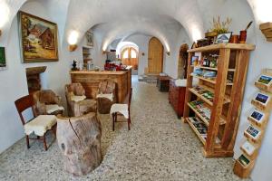 a room with a counter and chairs in a room at Tourist Farm Šenkova Domačija in Zgornje Jezersko