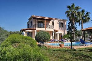 a house with a swimming pool in front of a house at Villa Paradise in Paphos