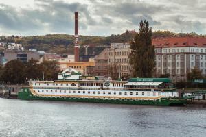 - un grand bateau vert et blanc sur l'eau dans l'établissement Admiral Botel, à Prague