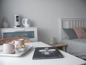 a table with a plate of food on it with a bed at Sea-Me Ostend in Ostend