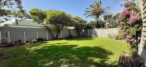 a yard with a fence and a tree in a yard at 7 on Henwick in Cape Town
