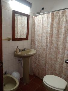 a bathroom with a sink and a toilet and a shower at BUNGALOWS JAUREGUIBEACH in Jaureguiberry