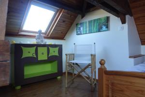 a bedroom with a bed and a chair and a tv at Chambres d'hôtes Les Magnolias in Saint-Chéron