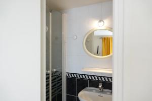 a bathroom with a sink and a mirror at Chambres d'hôtes Les Magnolias in Saint-Chéron