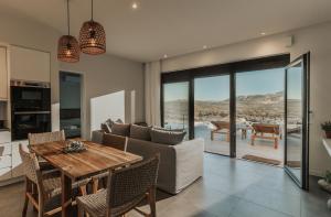 a living room with a couch and a table at Villa Panorama in Paleros