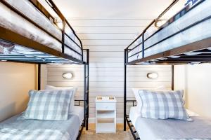 two beds in a room with two bunk beds at Casa Okemo in Ludlow