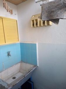 a small bathroom with a sink and a window at Departamento 6 personas con vista al mar in Mar de Ajó
