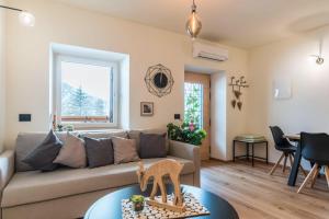 a living room with a couch and a table at Wellness Lodge Diletta in Santa Giuliana