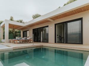 a villa with a swimming pool and a house at Villa Panorama in Paleros