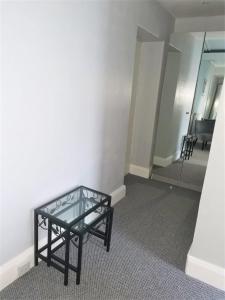 a glass table sitting in the middle of a room at Anglesey House in Llandudno