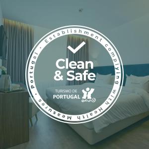 a sign that reads clean and safe in a bedroom at Hotel Moutados in Vila Nova de Famalicão