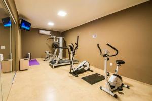 a gym with several exercise bikes in a room at Viageiro Casa Hotel in Pelotas