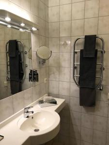 a bathroom with a sink and a mirror at Wärdshuset Bredaryd in Bredaryd