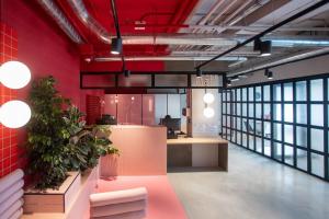 an office with pink walls and plants in a room at Residencia Universitaria Resa San Mamés in Bilbao