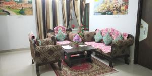 a living room with two chairs and a table at Varuna Palace Near Mandir & Ghat's Varanasi in Varanasi