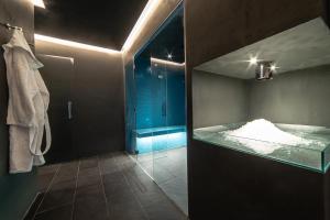 a bath room with a bath tub and a toilet at HB Aosta Hotel & Balcony SPA in Aosta