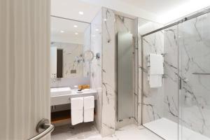 a bathroom with a shower, sink, and toilet at Grand Hotel Miramare in Santa Margherita Ligure