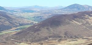 an aerial view of a mountain with snow capped mountains at Bannockburn Inn in Helmsdale